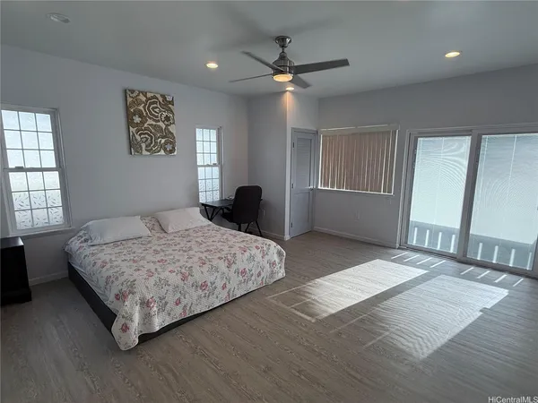 a bedroom with a large bed and a chandelier