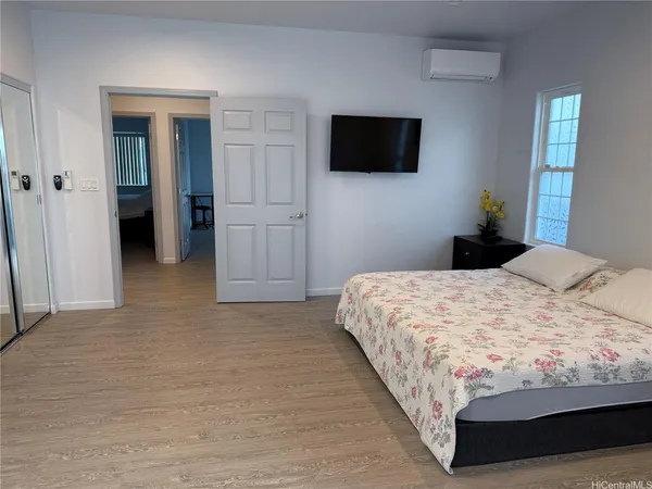 a bedroom with a bed and a flat screen tv