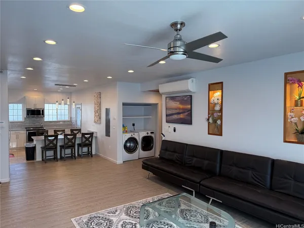 a living room with furniture and wooden floor