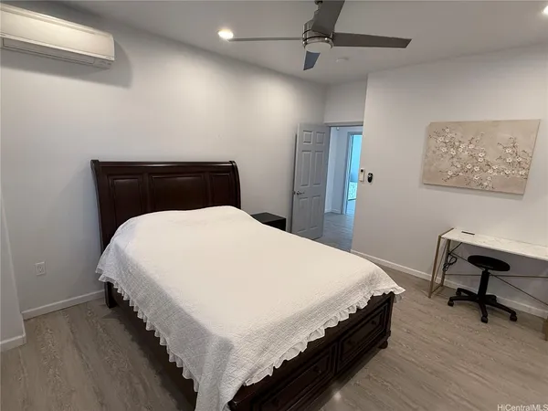 a bedroom with a bed and a desk