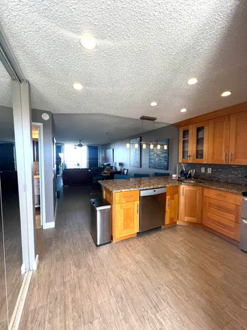 a kitchen with large cabinets a sink and appliances