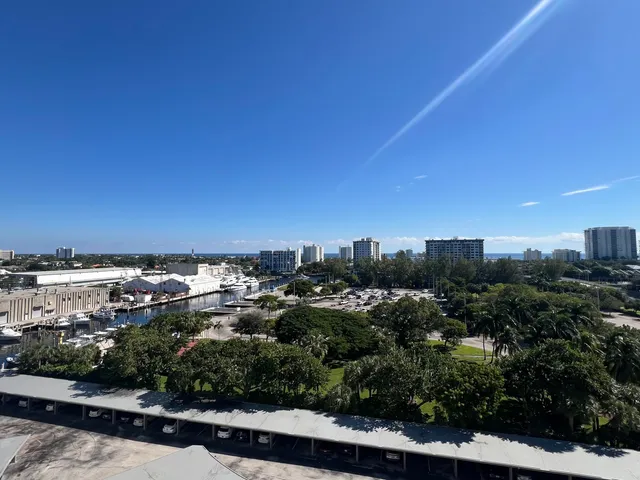 a view of a swimming pool with a lawn chairs under an umbrella