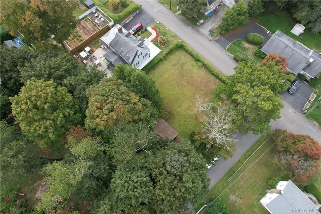 an aerial view of a house with a yard and lake view