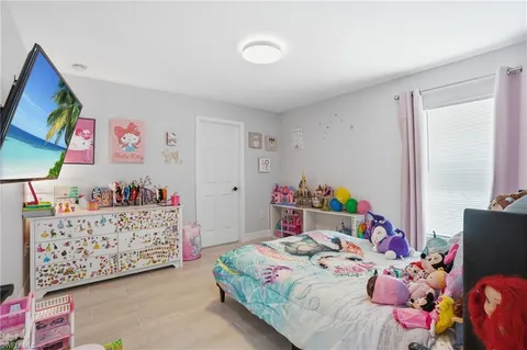 a bedroom with a bed and a baby bed