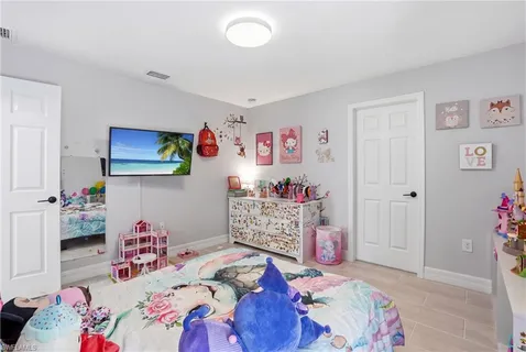 a bedroom with a bed and a dresser