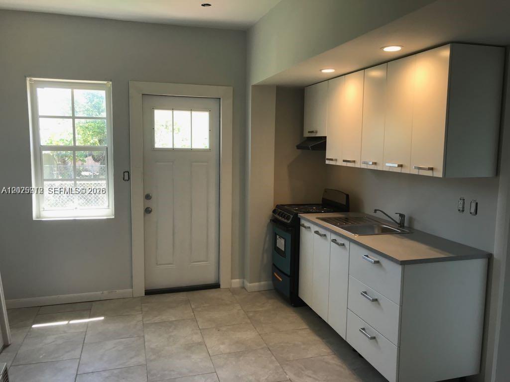 2224 Southwest 11th Street, Unit 3 Miami, FL 33135 - Photo 3 of 15 a kitchen with a sink stove and cabinets