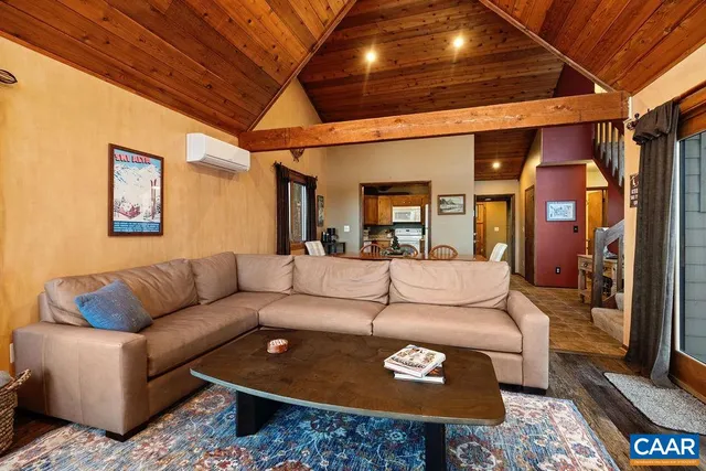 a living room with furniture a rug and a chandelier