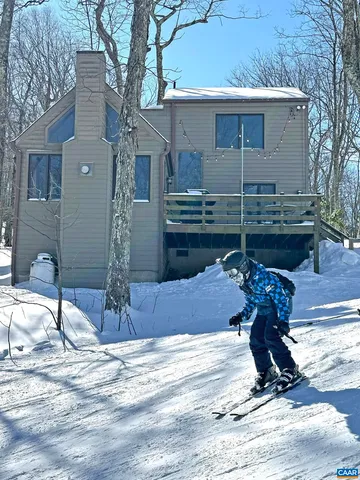 a view of the house with snow on the road