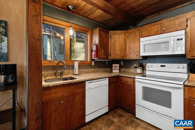 a kitchen with a refrigerator sink and cabinets