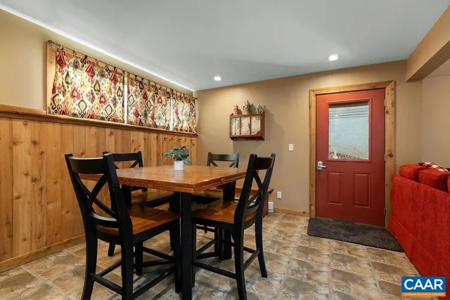 a bathroom with a granite countertop sink vanity mirror and toilet