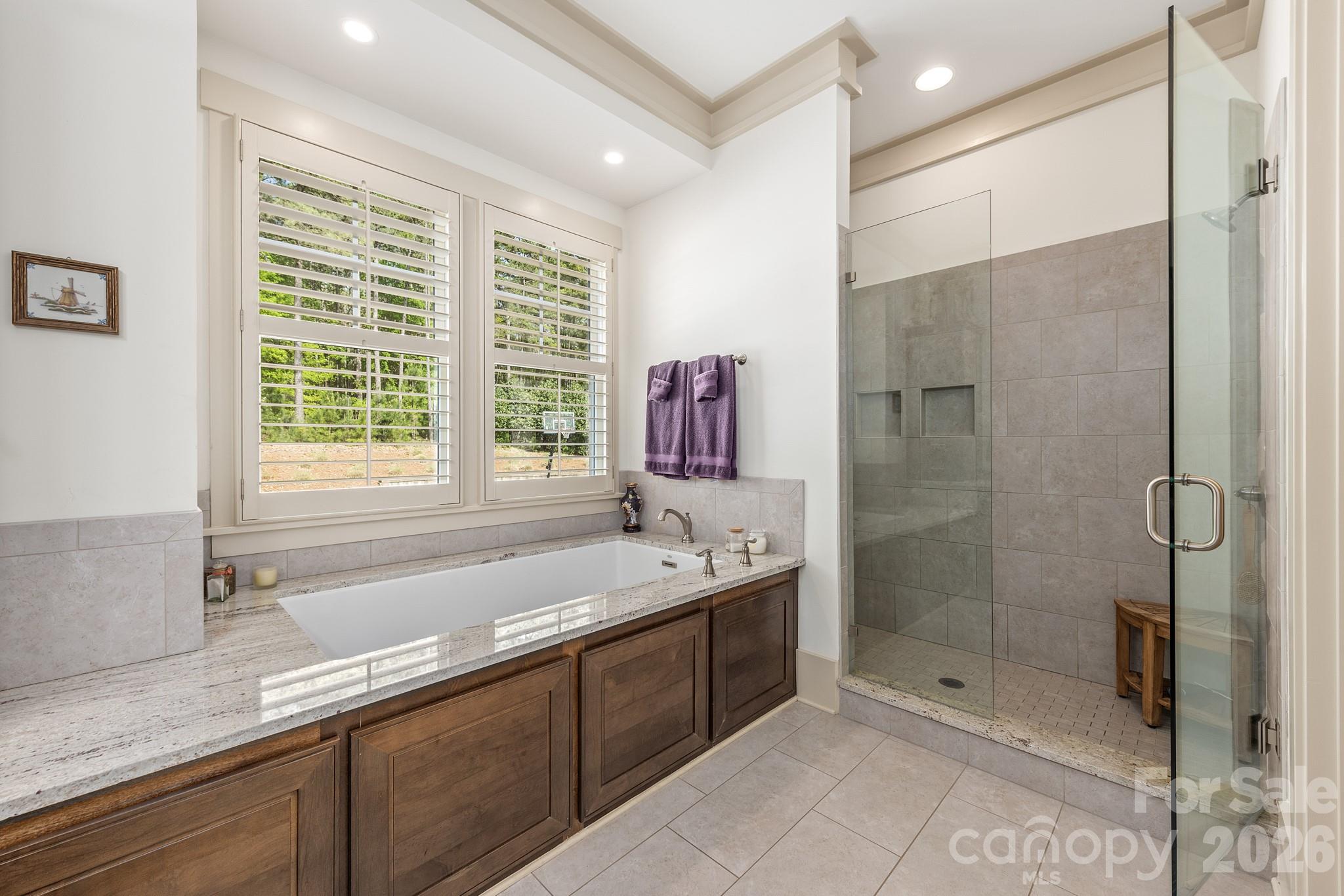 18321 Rosapenny Road Charlotte, NC 28278 - Photo 12 of 40 a bathroom with a shower sink and mirror