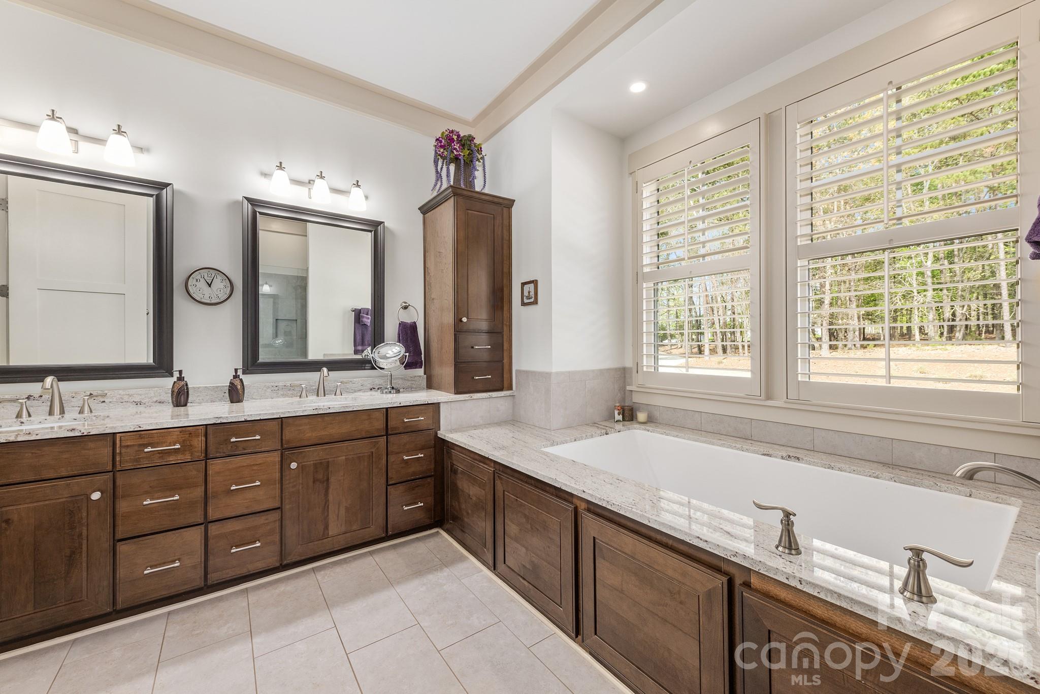 18321 Rosapenny Road Charlotte, NC 28278 - Photo 13 of 40 a large bathroom with double vanity and a large mirror