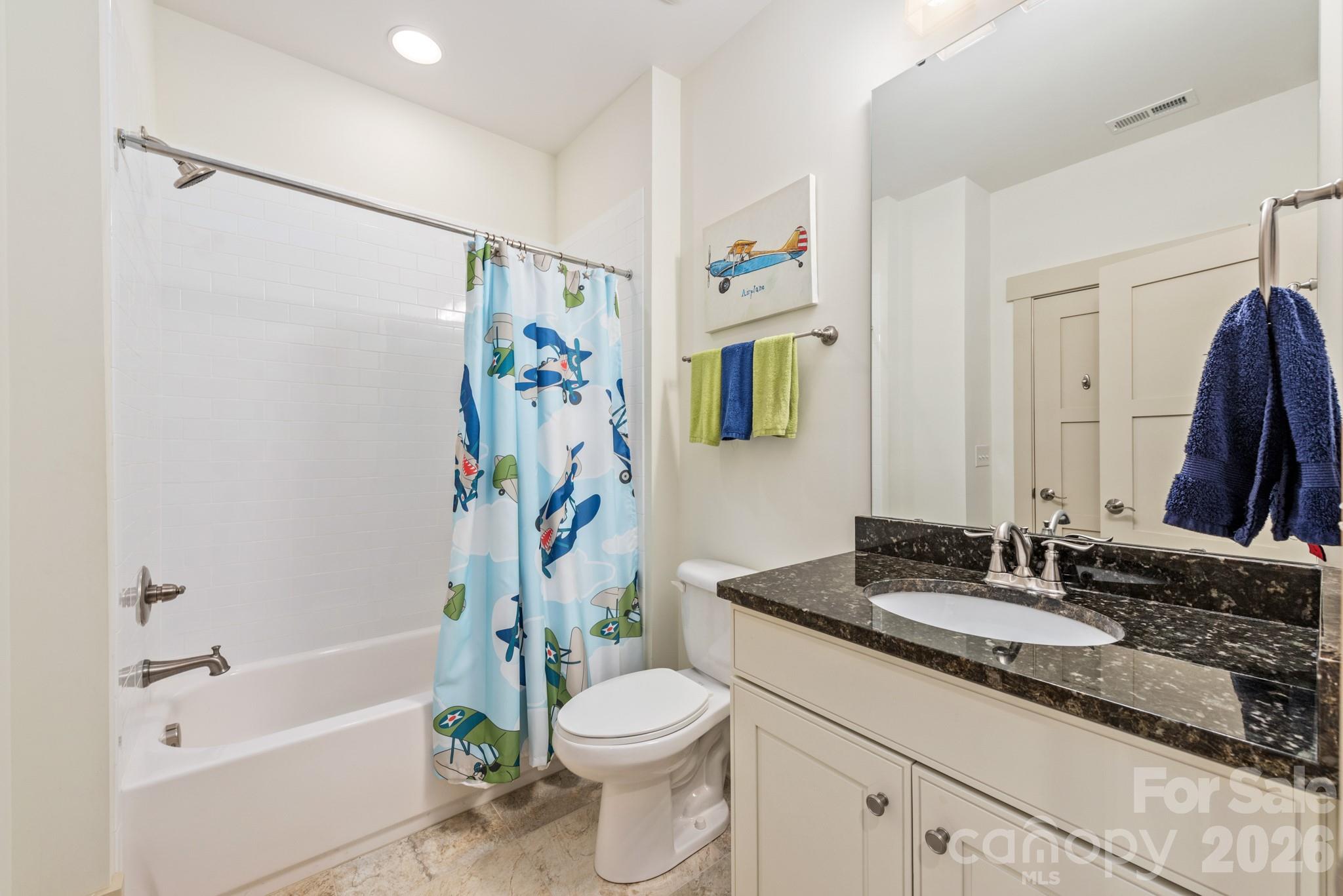 18321 Rosapenny Road Charlotte, NC 28278 - Photo 22 of 40 a bathroom with a granite countertop sink toilet a shower curtain and a large mirror