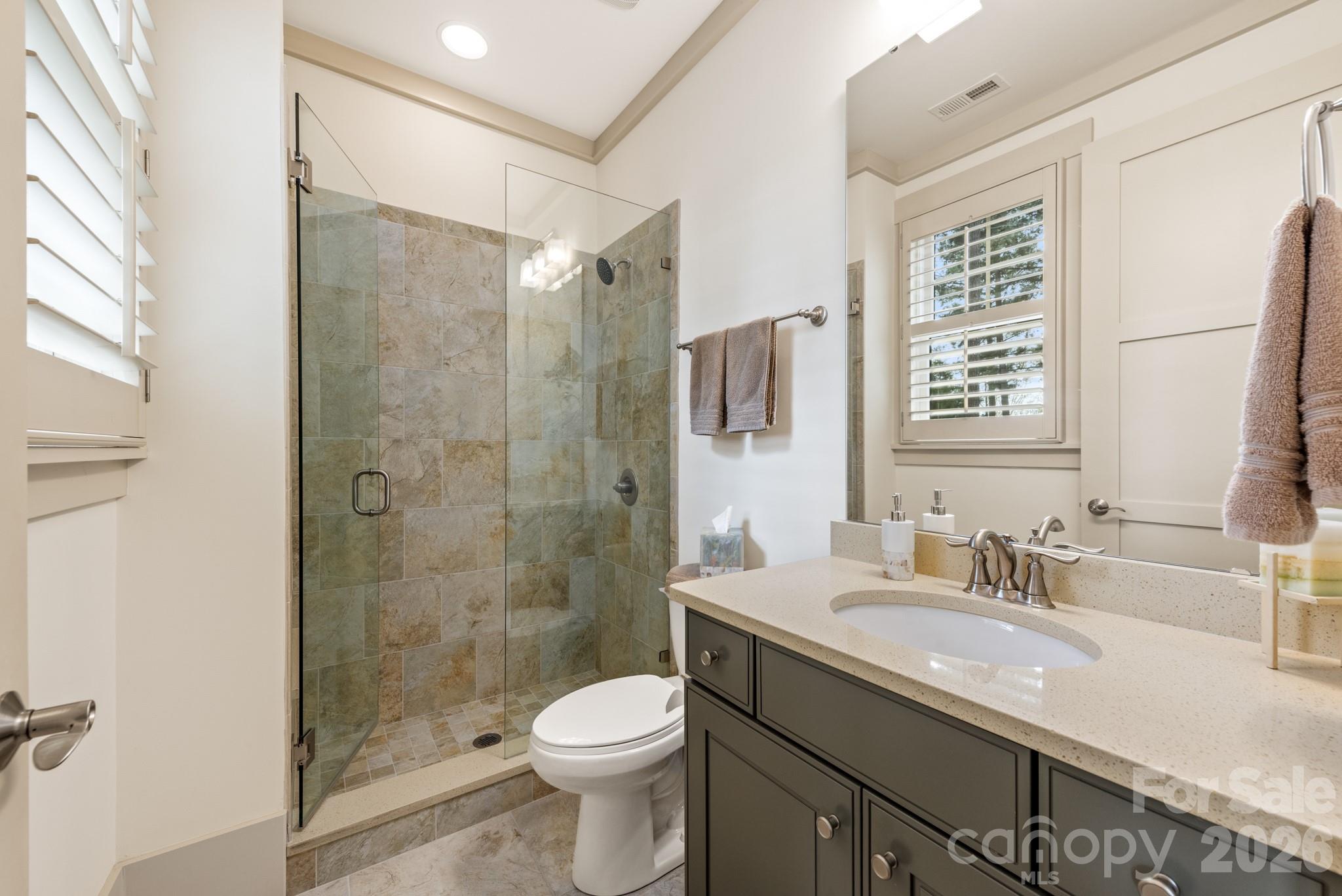 18321 Rosapenny Road Charlotte, NC 28278 - Photo 28 of 40 a bathroom with a granite countertop sink toilet and shower