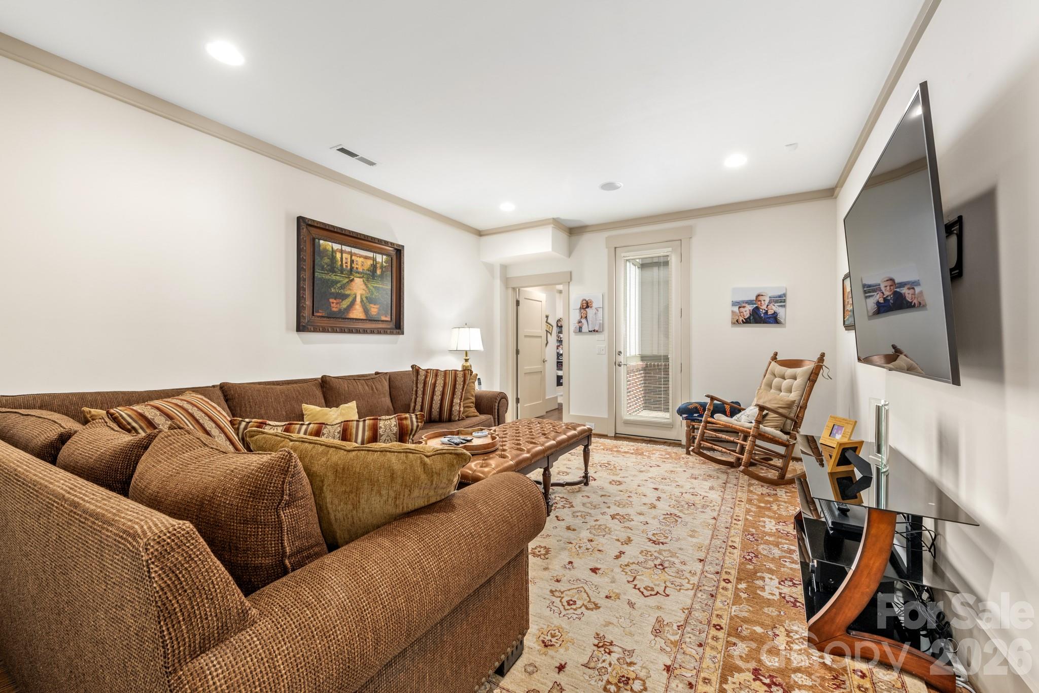 18321 Rosapenny Road Charlotte, NC 28278 - Photo 30 of 40 a living room with furniture and a flat screen tv