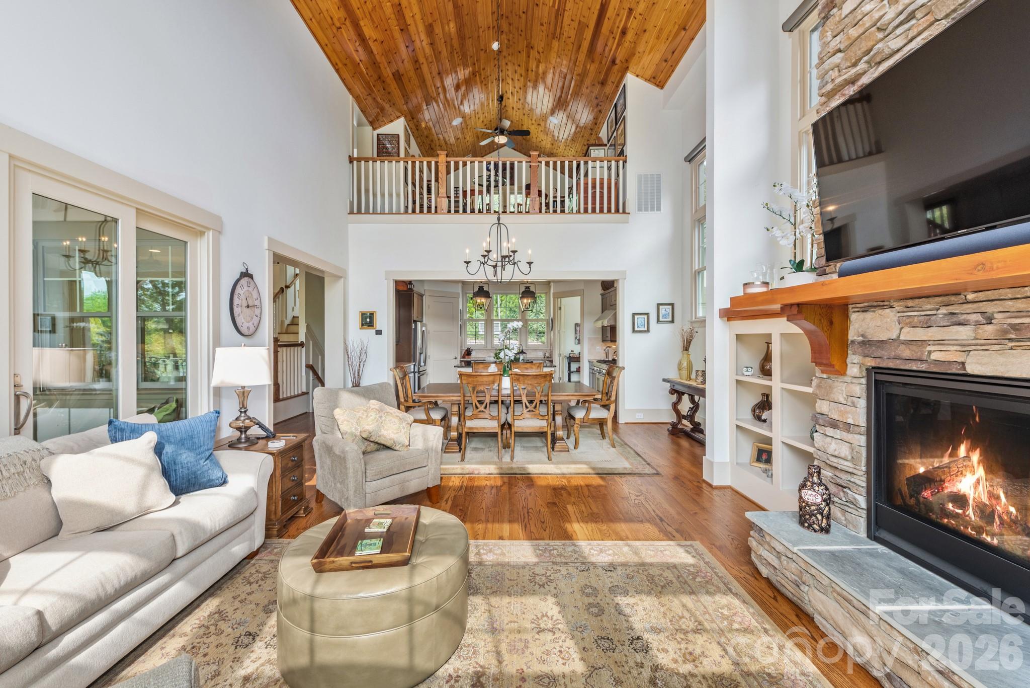 18321 Rosapenny Road Charlotte, NC 28278 - Photo 5 of 40 a living room with furniture a fireplace and a flat screen tv
