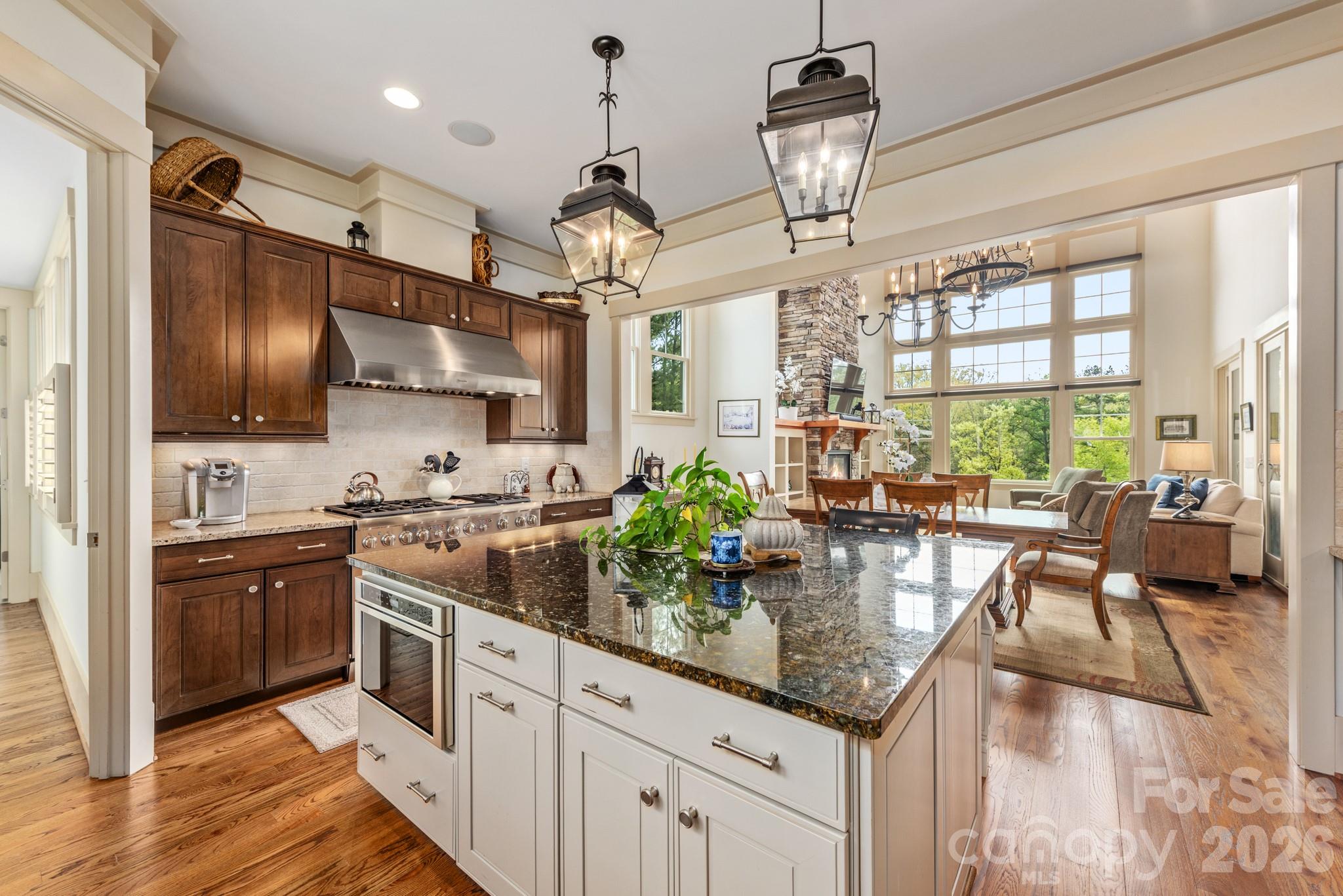18321 Rosapenny Road Charlotte, NC 28278 - Photo 6 of 40 a kitchen with stainless steel appliances granite countertop a stove refrigerator and cabinets