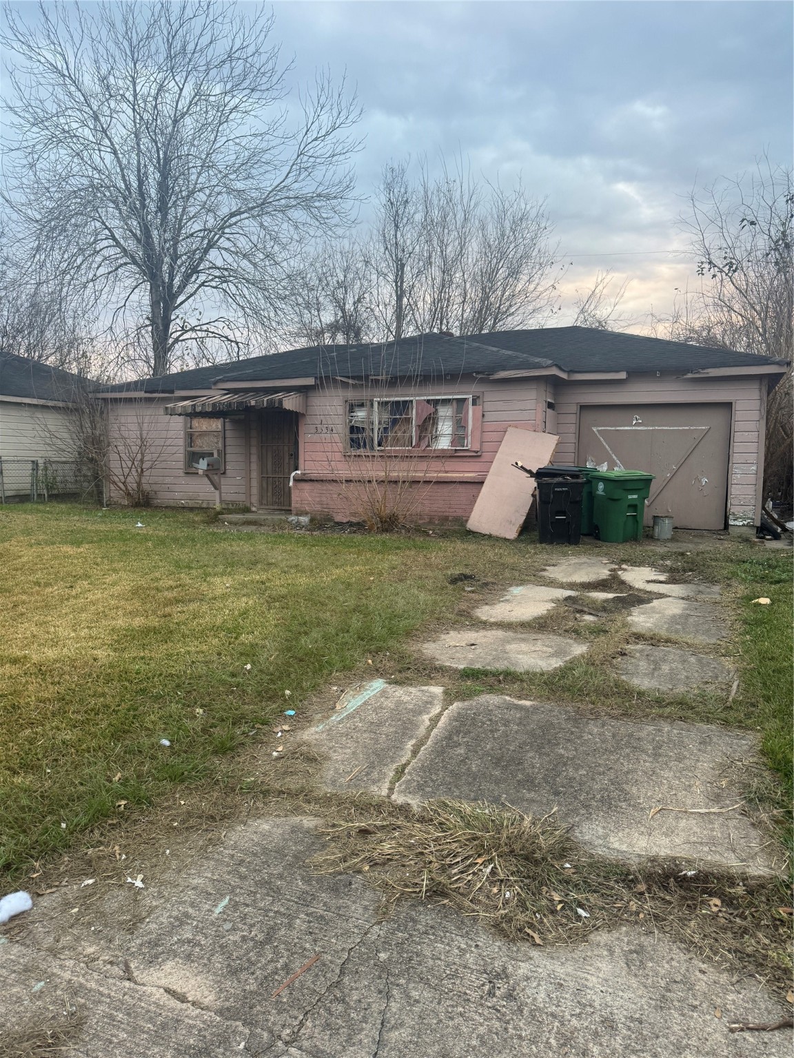 a view of a house with backyard and trees in the background