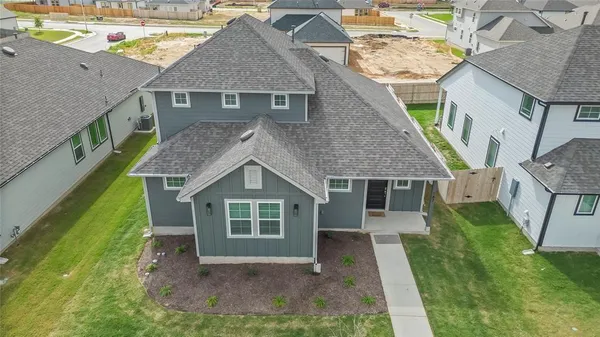 a front view of house with backyard and green space
