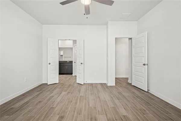 an empty room with wooden floor and closet