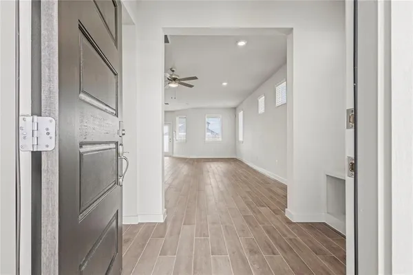 a view of empty room with wooden floor and window