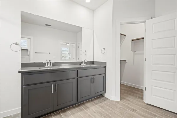 a bathroom with a granite countertop sink and a mirror