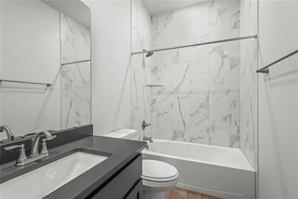 a bathroom with a sink toilet a mirror and shower