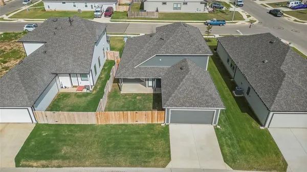 an aerial view of a house with a yard