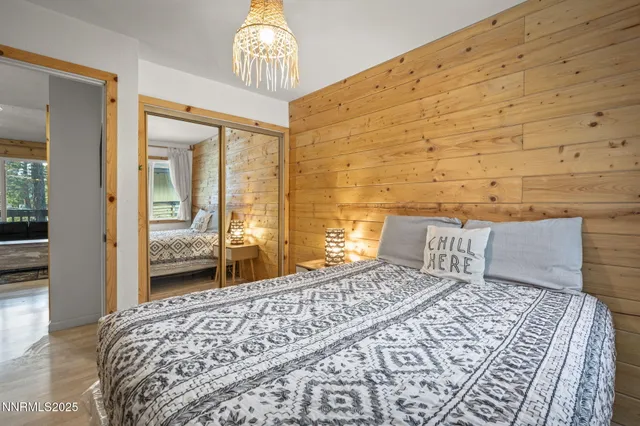 a bedroom with a large bed and a chandelier