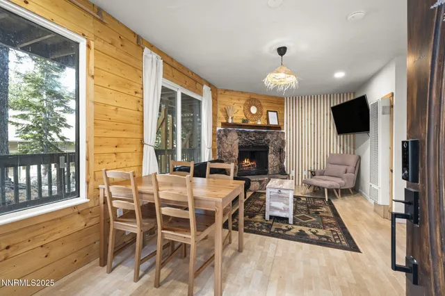 a view of a livingroom with furniture a fireplace and wooden floor