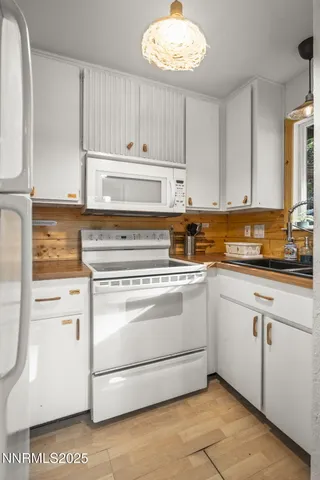 a kitchen with appliances cabinets and a sink
