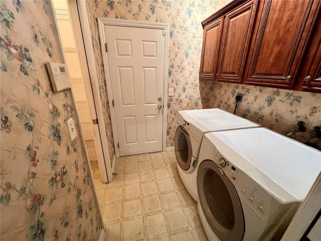 11097 Southwest 69th Circle Ocala, FL 34476 - Photo 5 of 16 a utility room with dryer and washer