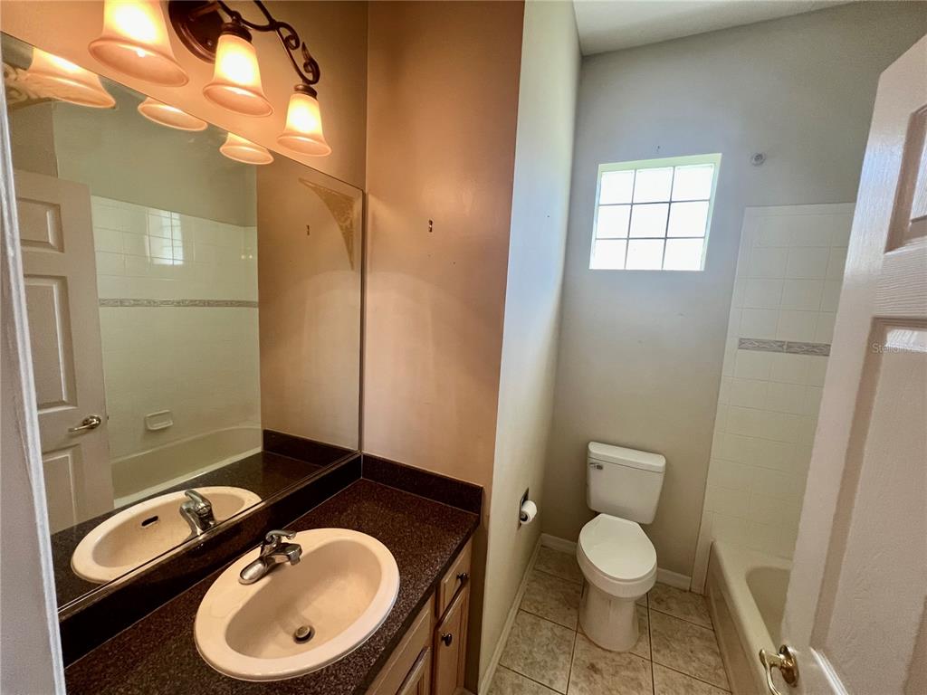 11097 Southwest 69th Circle Ocala, FL 34476 - Photo 8 of 16 a bathroom with a toilet a sink and mirror