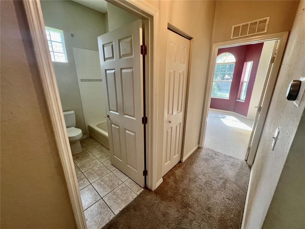 11097 Southwest 69th Circle Ocala, FL 34476 - Photo 9 of 16 a view of a hallway with wooden floor and a door