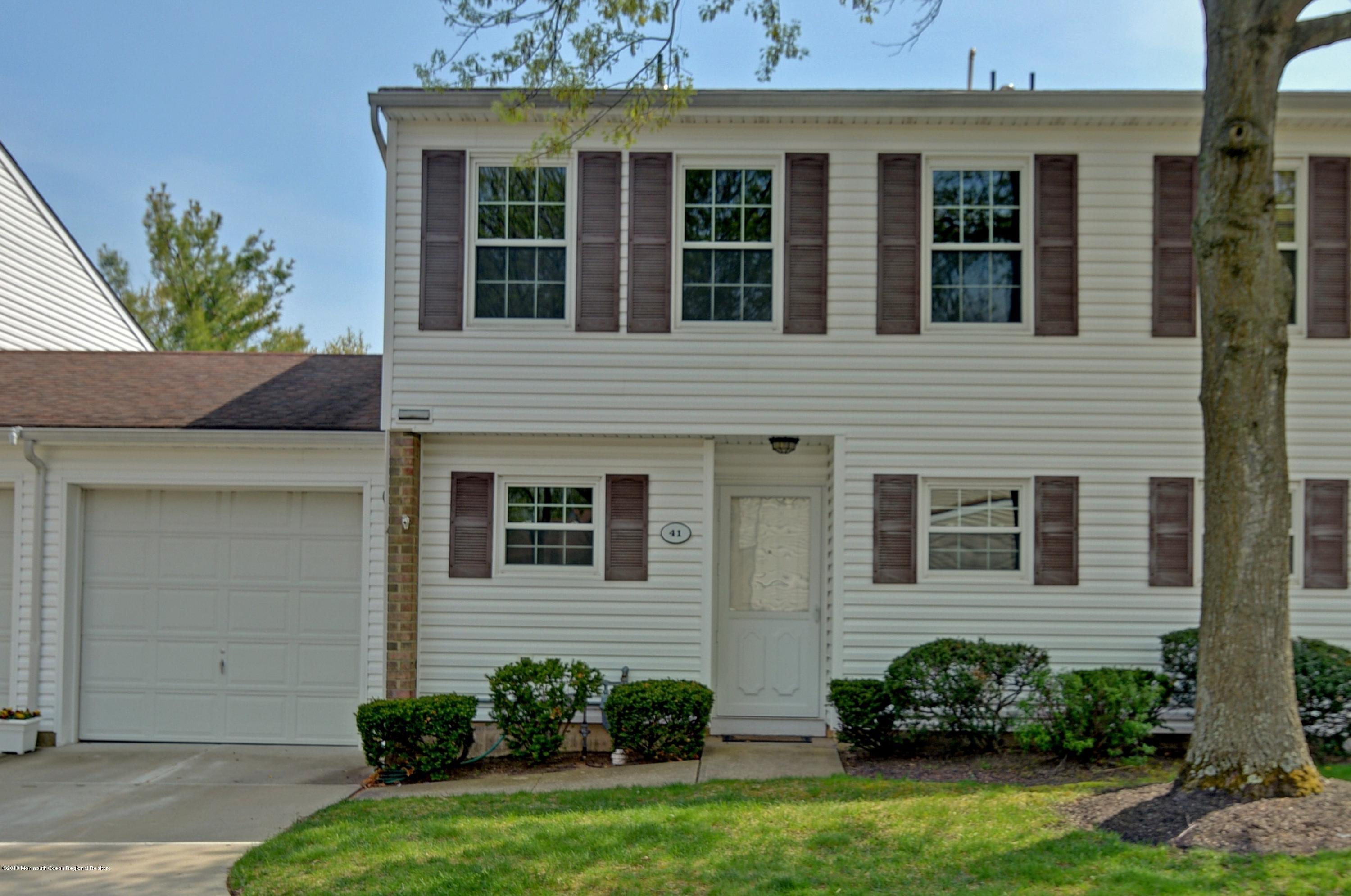 41 Apple Drive Spring Lake Heights, NJ 07762 - Photo 1 of 32 a view of a house with many windows and plants