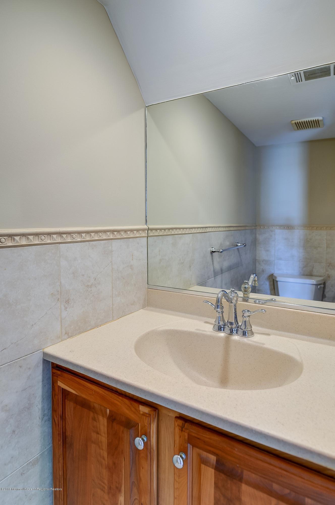 41 Apple Drive Spring Lake Heights, NJ 07762 - Photo 11 of 32 a bathroom with a sink and a shower