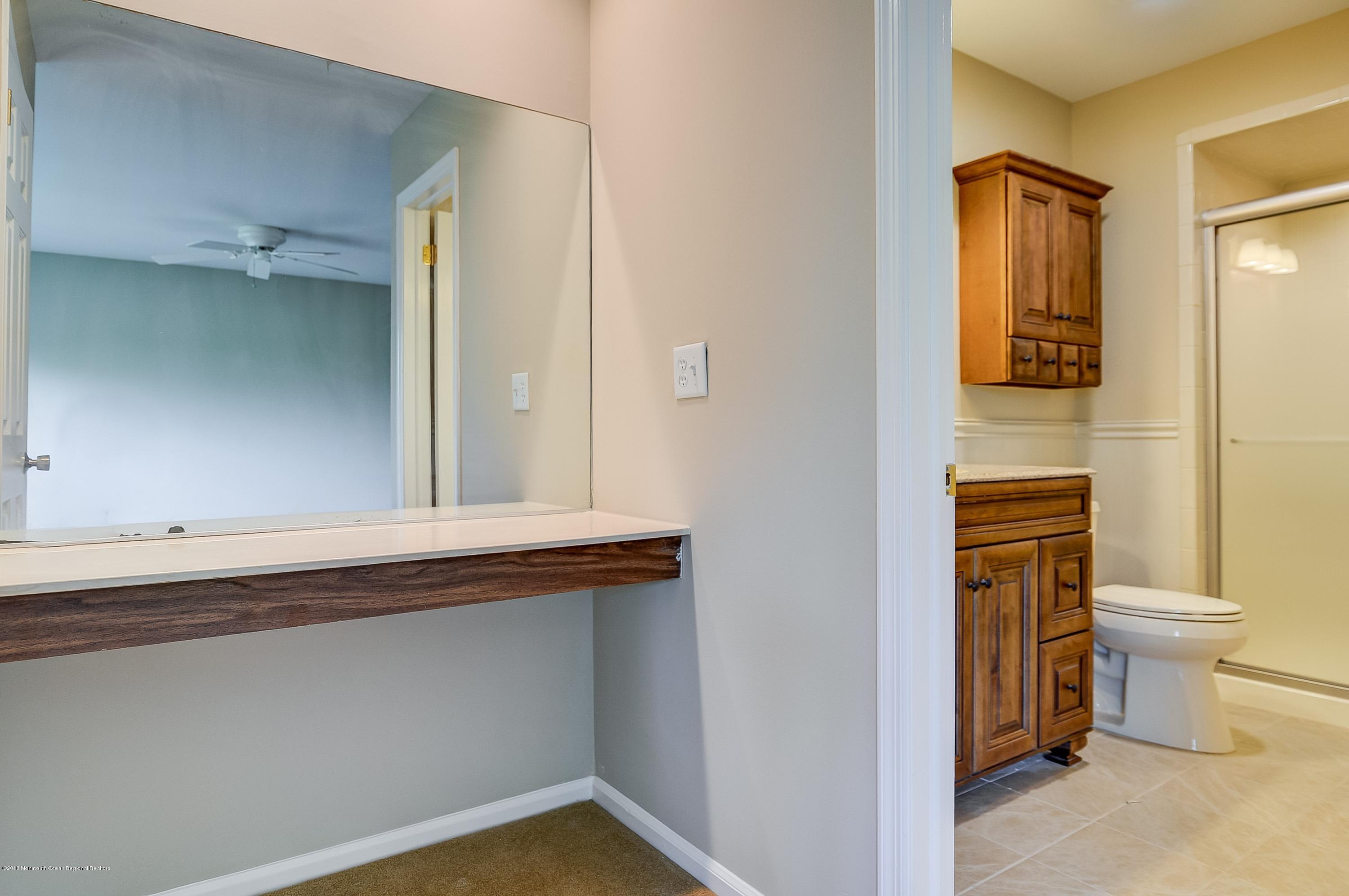 41 Apple Drive Spring Lake Heights, NJ 07762 - Photo 15 of 32 a bathroom with a toilet sink and mirror