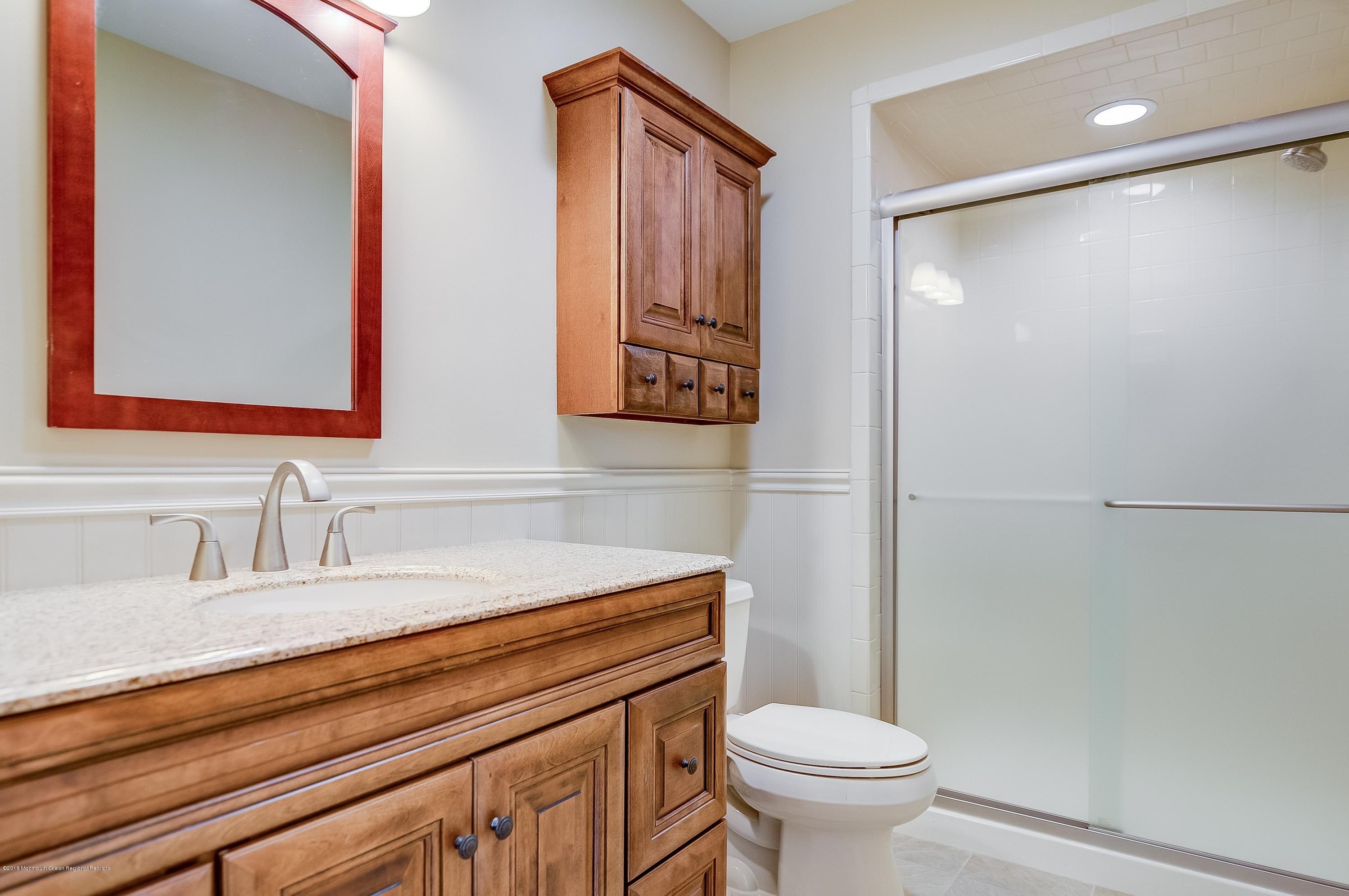 41 Apple Drive Spring Lake Heights, NJ 07762 - Photo 16 of 32 a bathroom with a toilet sink and mirror