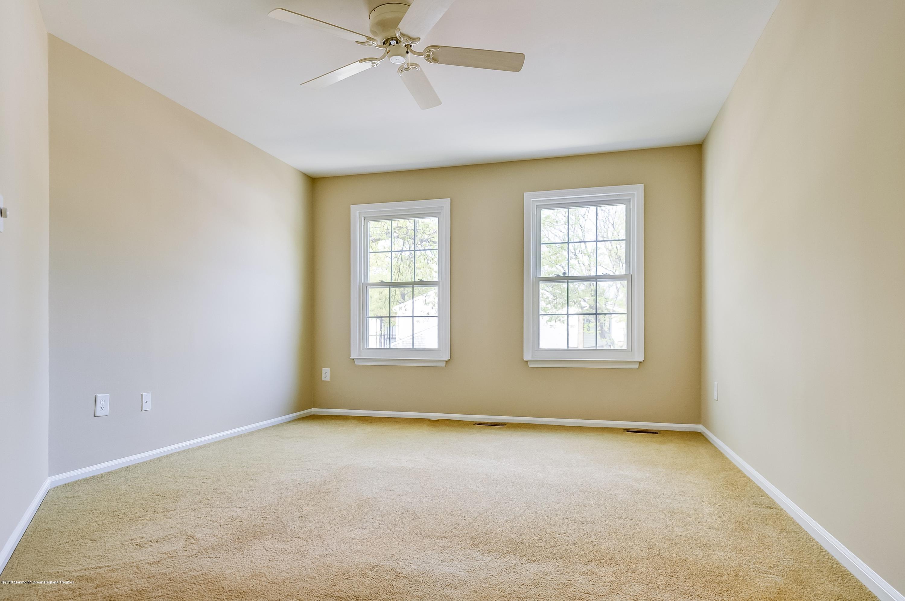 41 Apple Drive Spring Lake Heights, NJ 07762 - Photo 18 of 32 an empty room with windows and fan