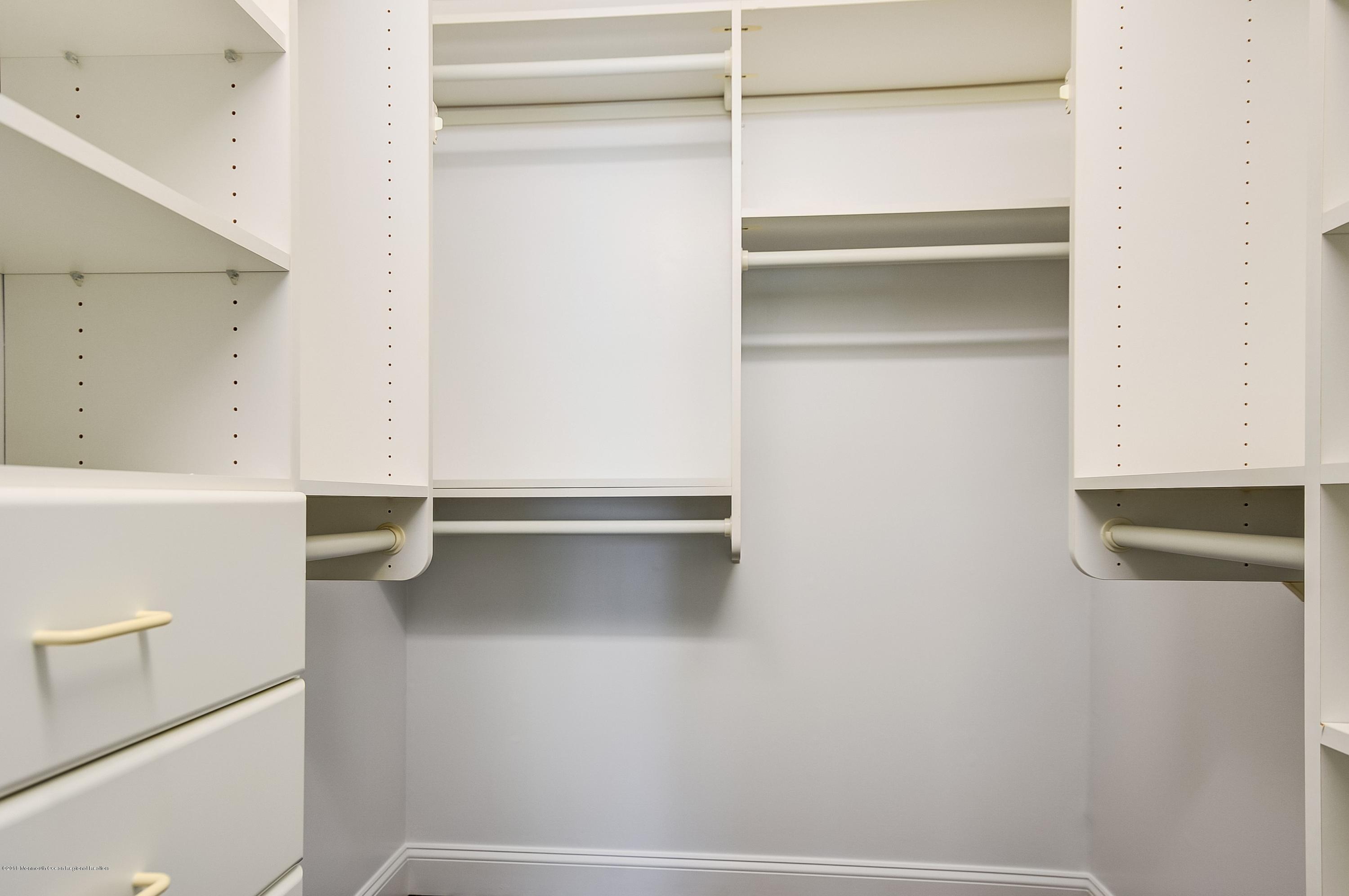 41 Apple Drive Spring Lake Heights, NJ 07762 - Photo 19 of 32 a view of walk in closet with empty racks