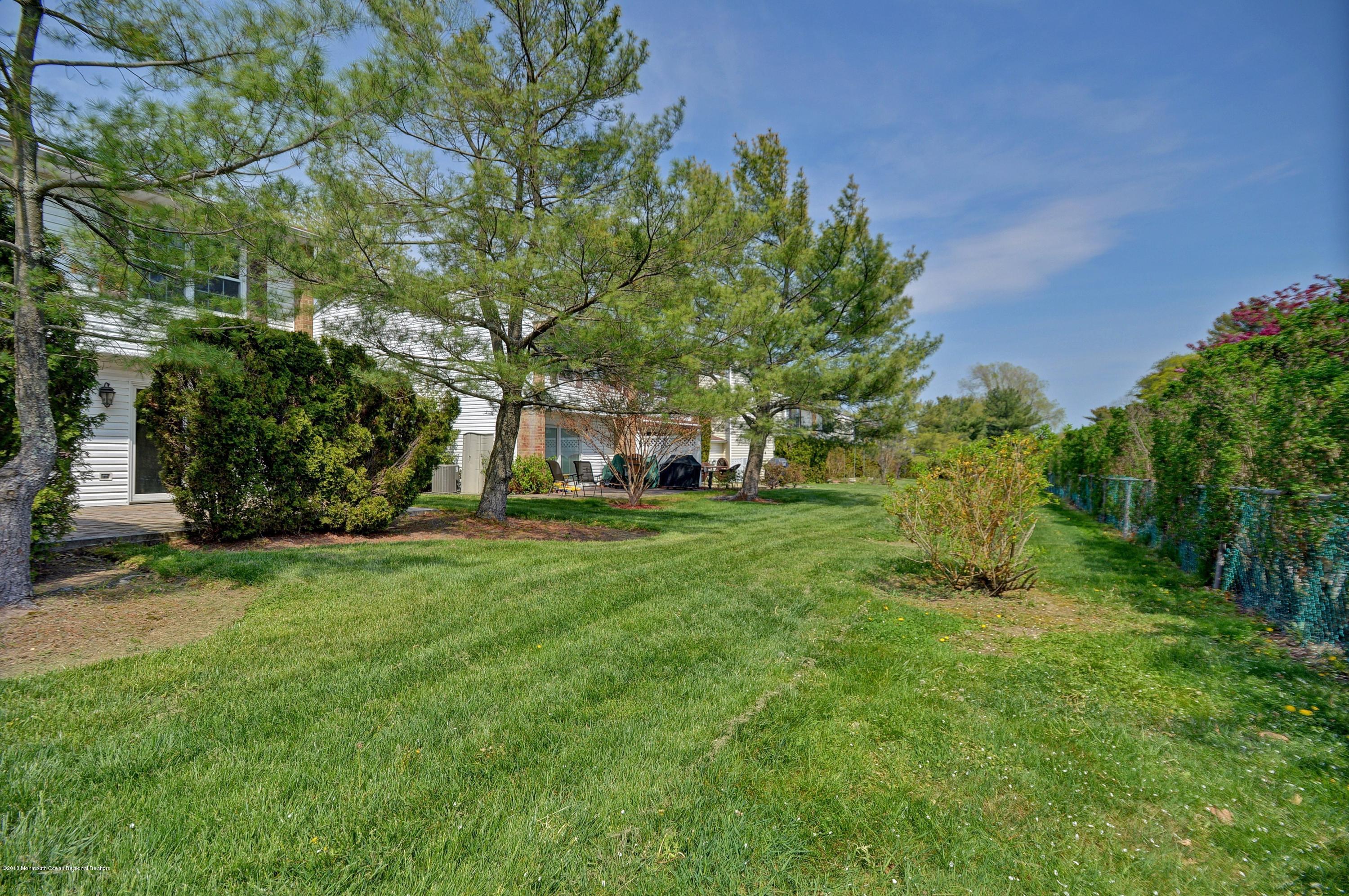 41 Apple Drive Spring Lake Heights, NJ 07762 - Photo 26 of 32 a view of a backyard with large trees