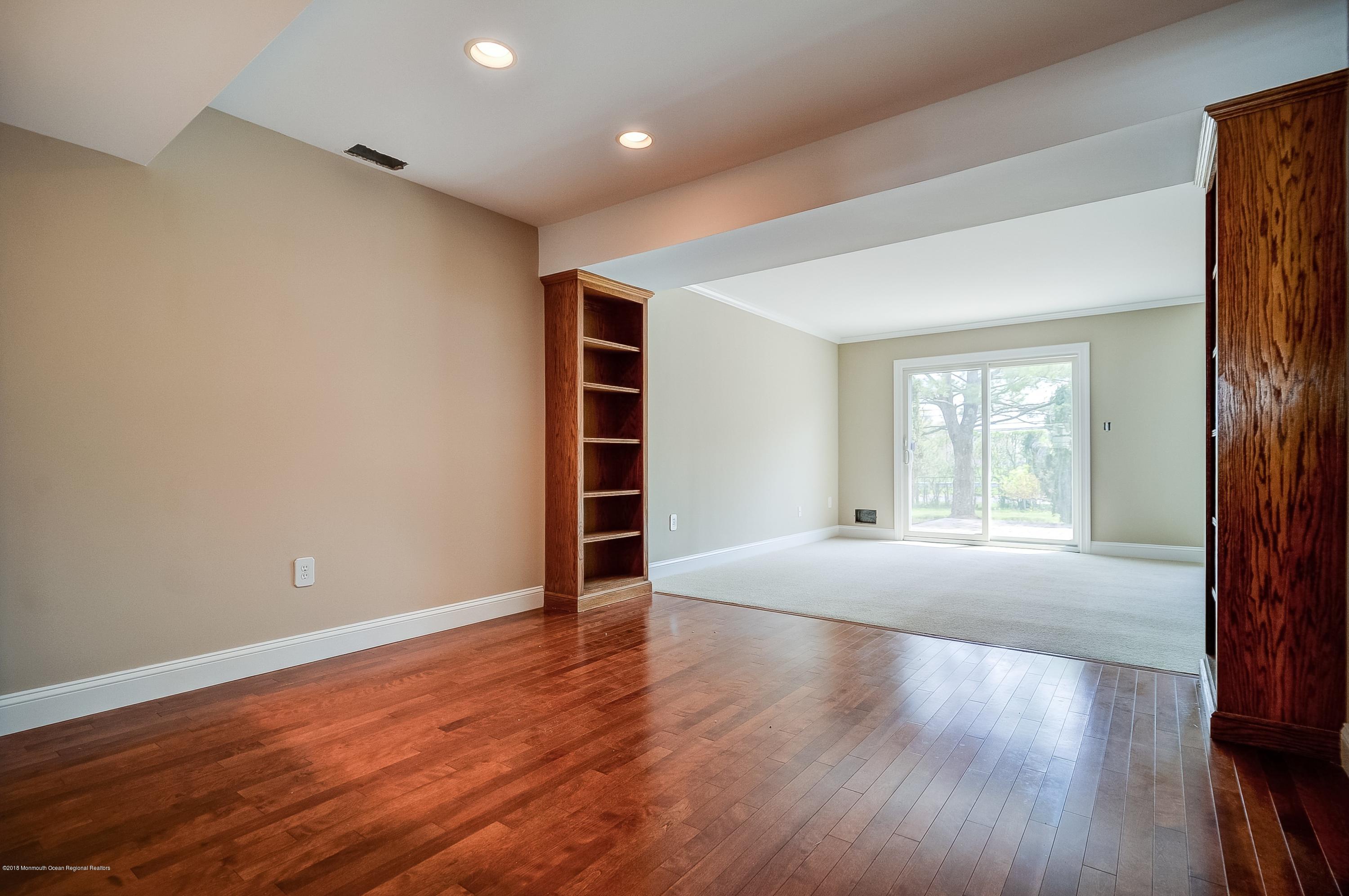 41 Apple Drive Spring Lake Heights, NJ 07762 - Photo 4 of 32 a view of an empty room with a window and wooden floor