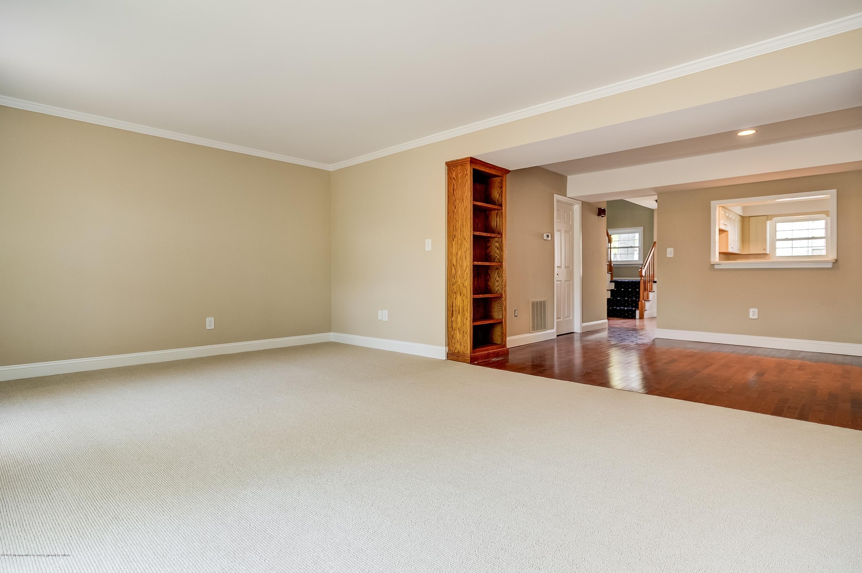 41 Apple Drive Spring Lake Heights, NJ 07762 - Photo 5 of 32 a view of an empty room with wooden floor and a window