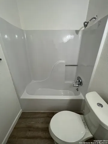 a bathroom with a toilet and a bathtub