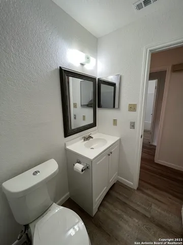 a bathroom with a toilet sink and mirror