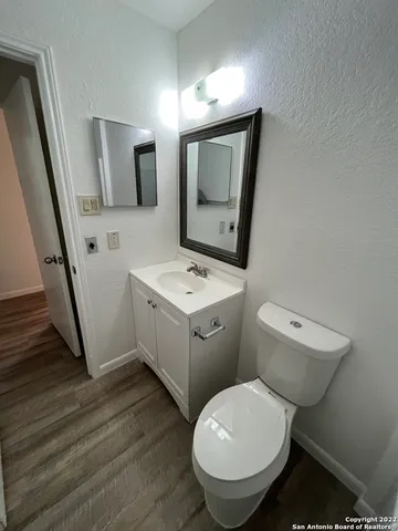 a bathroom with a toilet sink and mirror