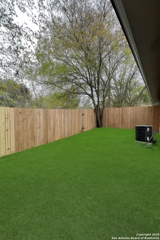 a view of a backyard with large trees