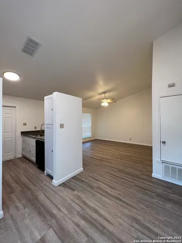 a view of a kitchen with a sink and a refrigerator