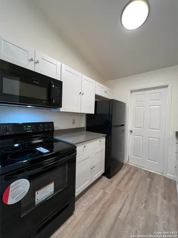 a kitchen with a sink and a stove top oven