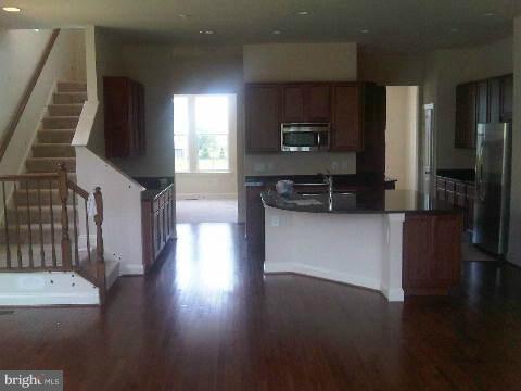 9839 Garden Ranges Laurel, MD 20723 - Photo 12 of 12 a kitchen with stainless steel appliances a refrigerator microwave and stove